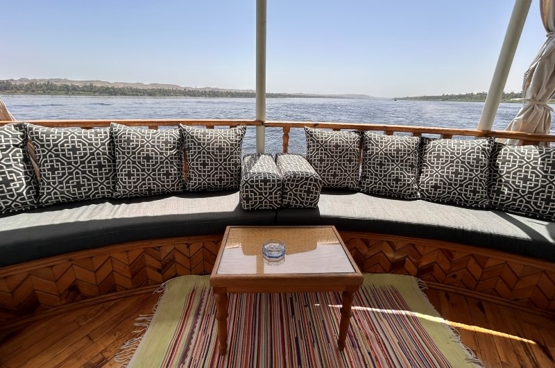 Nile-view balcony seating aboard Queen Farida