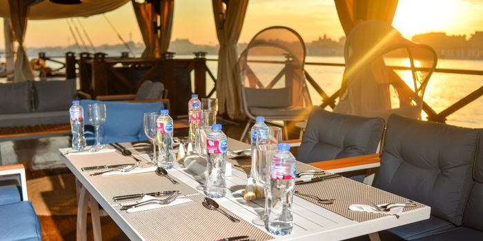 Deck dining table aboard Queens by TIME