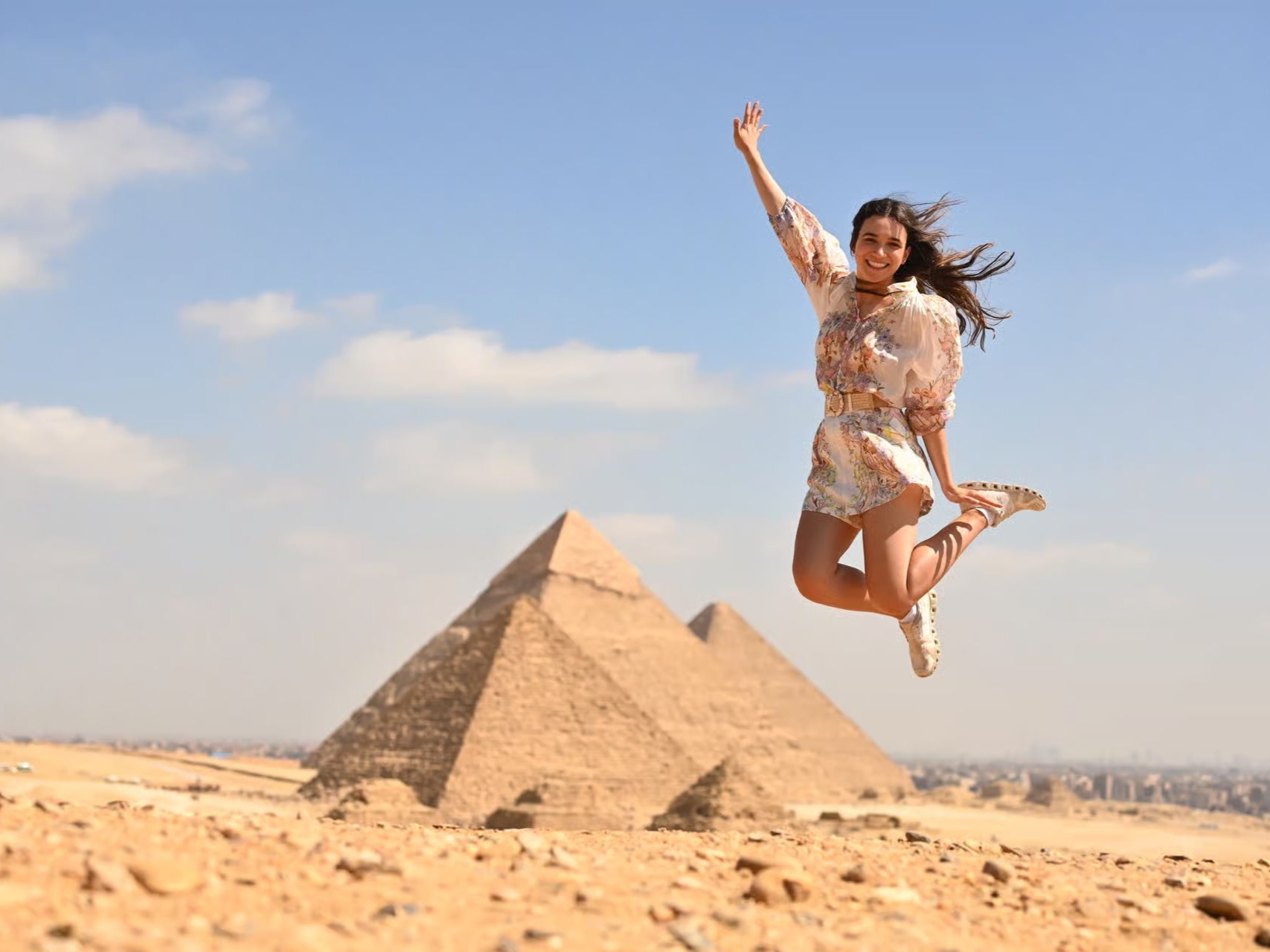 Tourist jumping at the Giza Pyramids