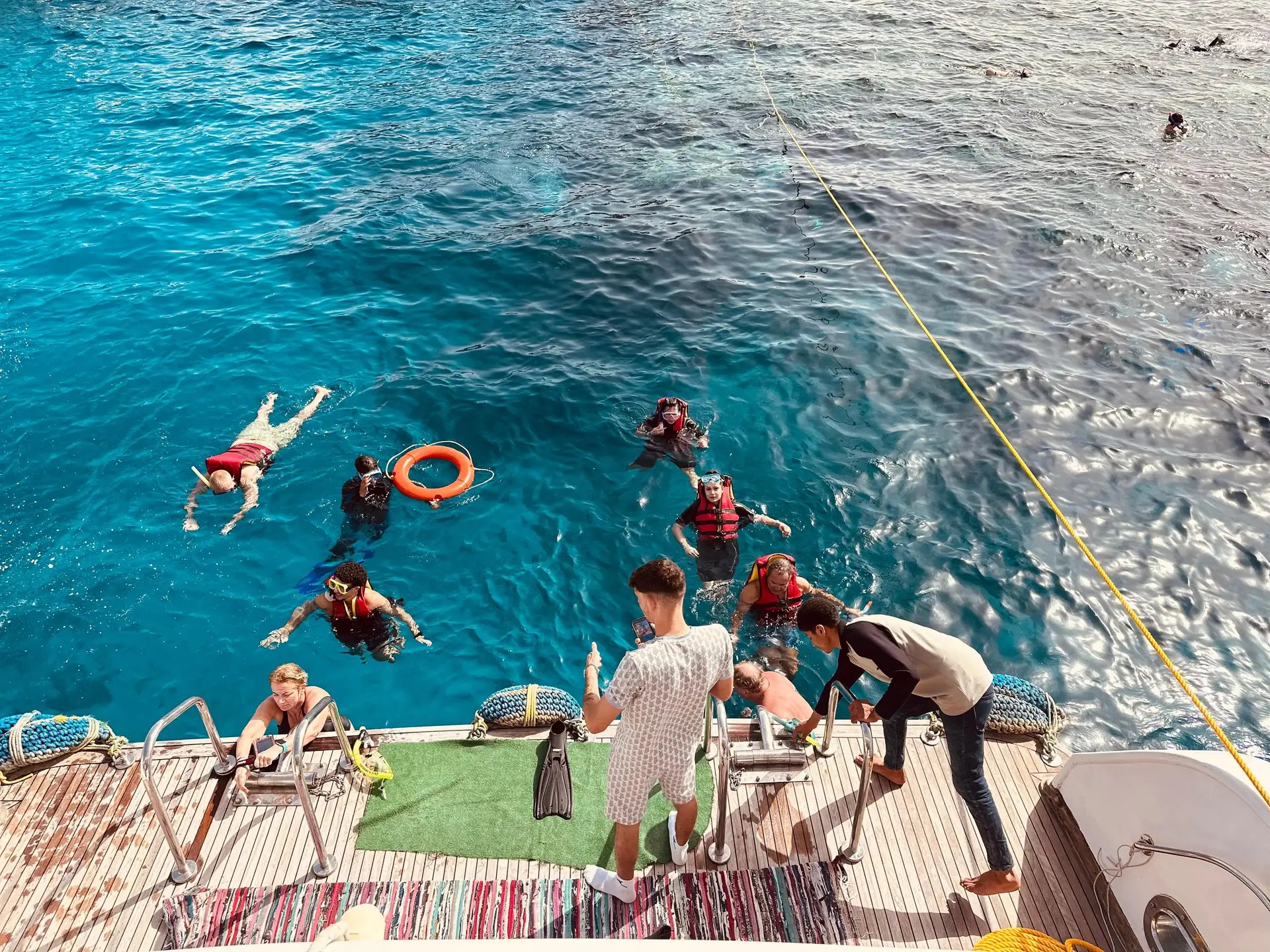 Passengers looking through large underwater windows at the sea floor